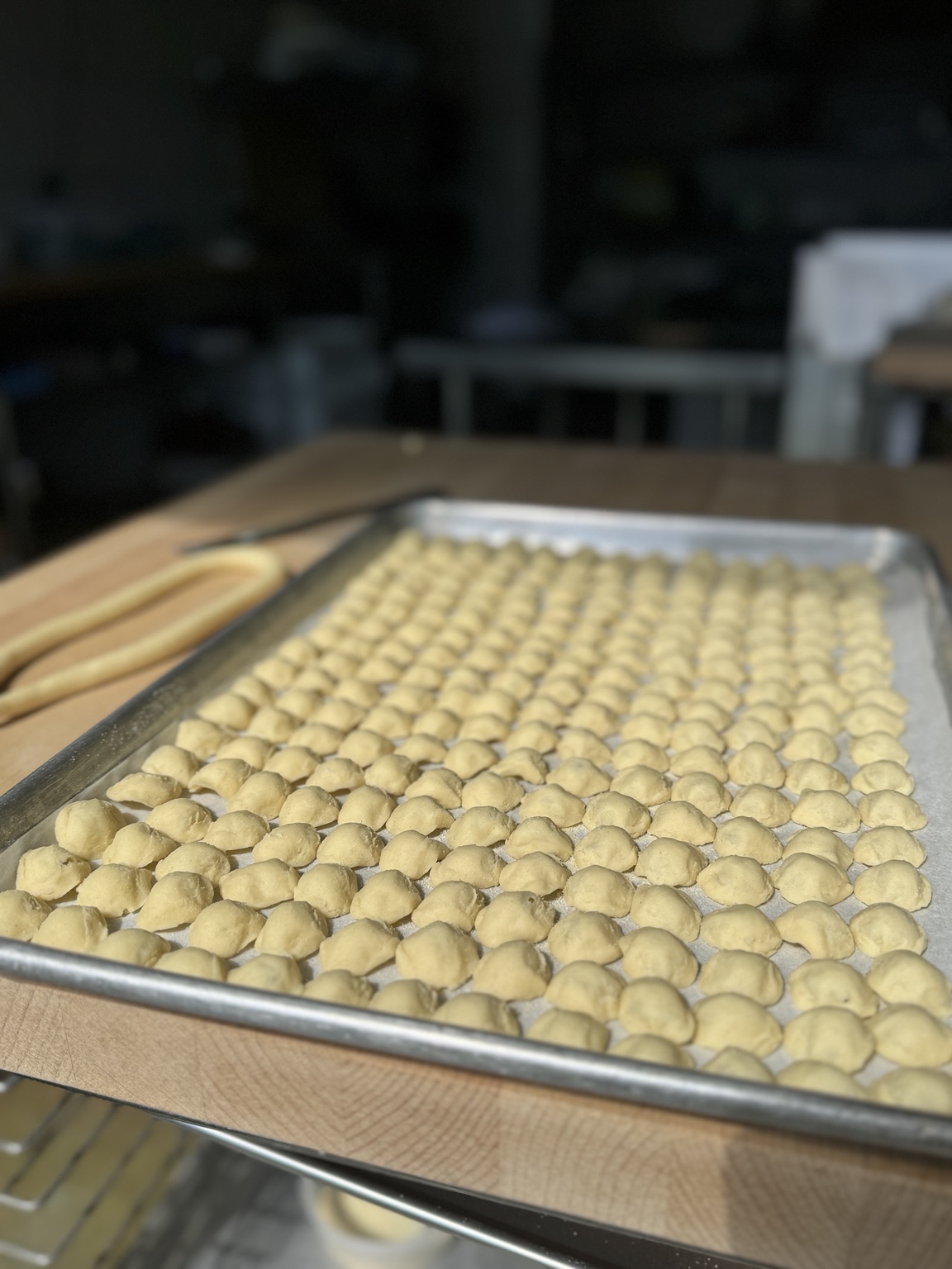Fresh handmade pasta arranged on a sheet pan in the Tackle Box dough lab.